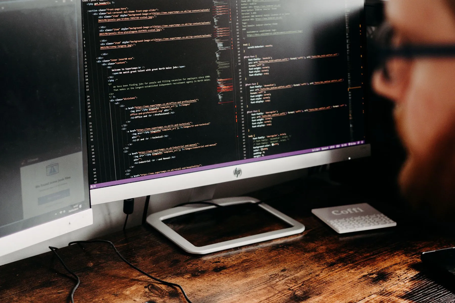 Application code on a monitor in a darkened workspace