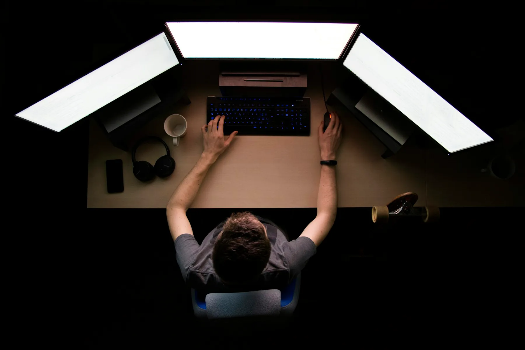 An engineer working at a desk under task lighting