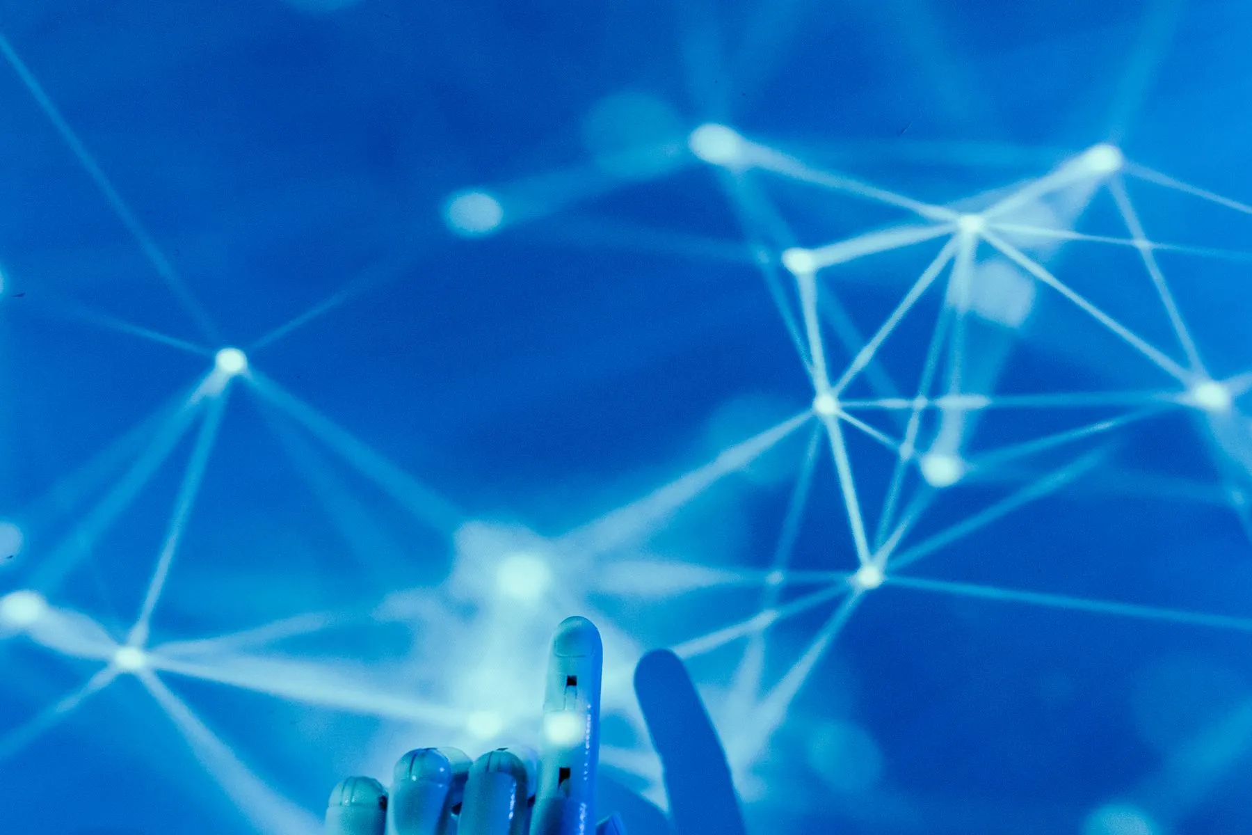 A connected network of data points reaching toward a hand
