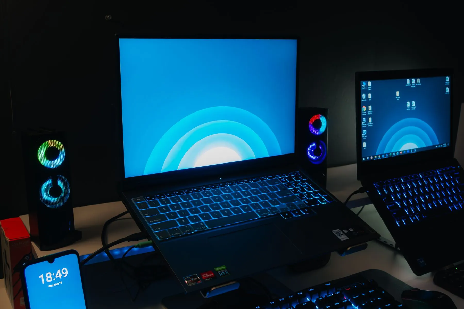 A managed desk setup of laptop, monitors and phone