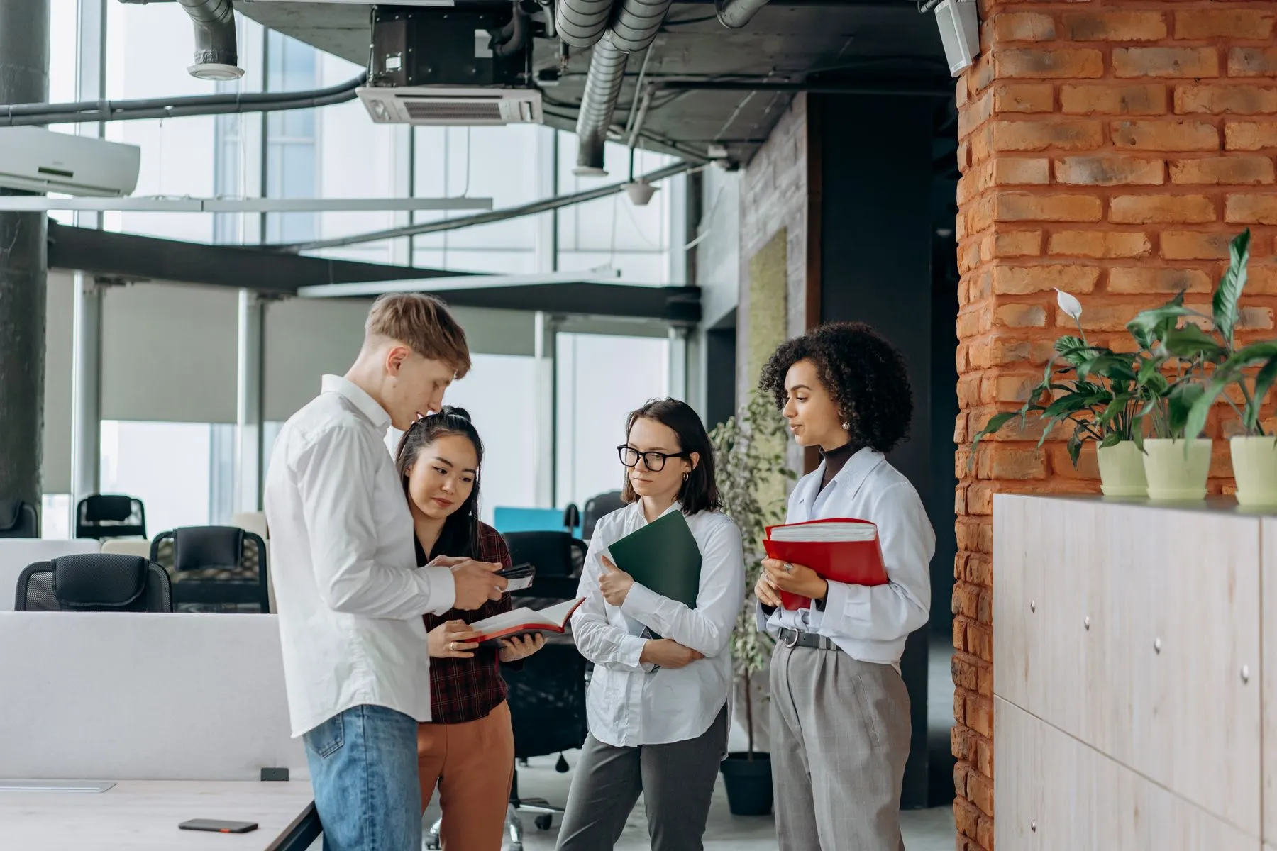 Colleagues talking in a modern open-plan office